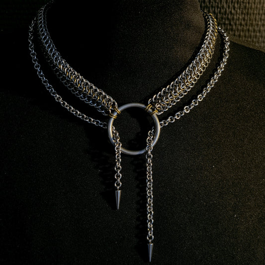 Necklace with chain and spike details on a black background