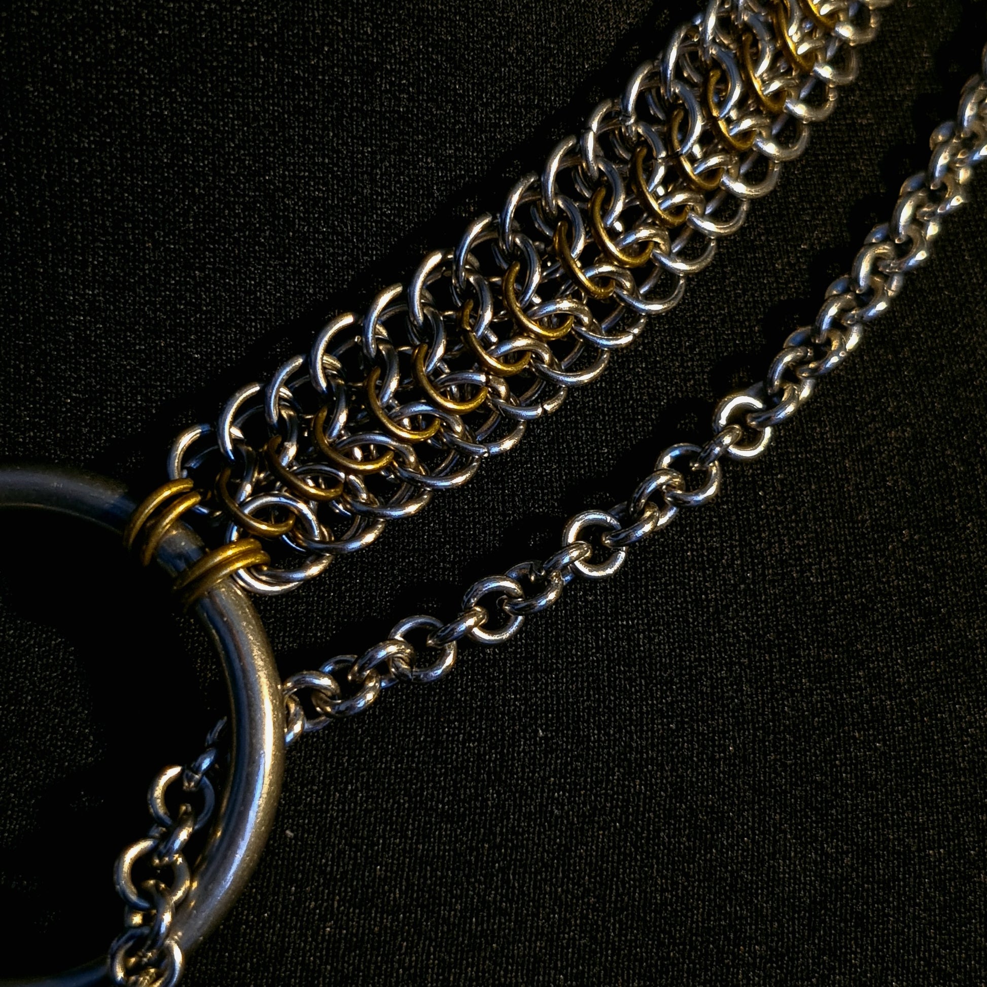 Close-up of a chain necklace on a black background