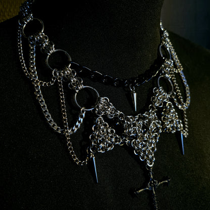 gothic alternative necklace with chain and spike design on a black background with cross