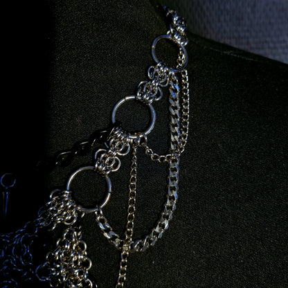 Close-up of an alternative gothic silver chain necklace on a black background