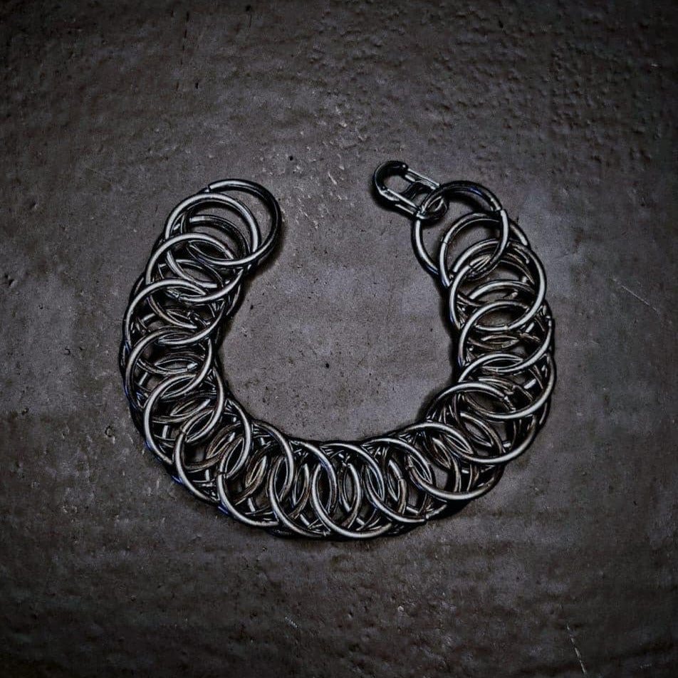 Silver chain bracelet on a dark textured surface