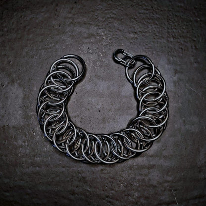 Silver chain bracelet on a dark textured surface
