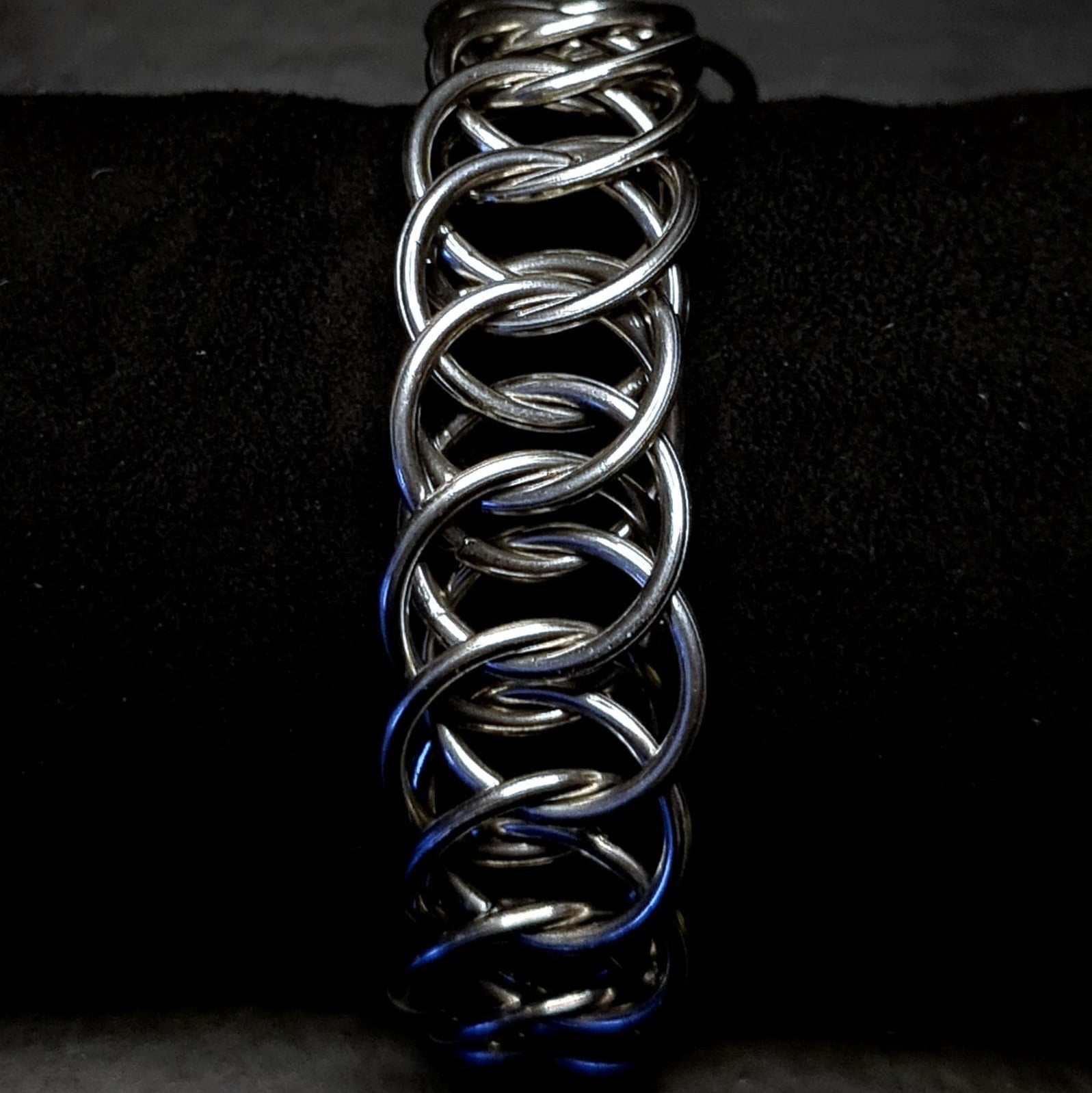 Metallic chain unisex bracelet on a dark background