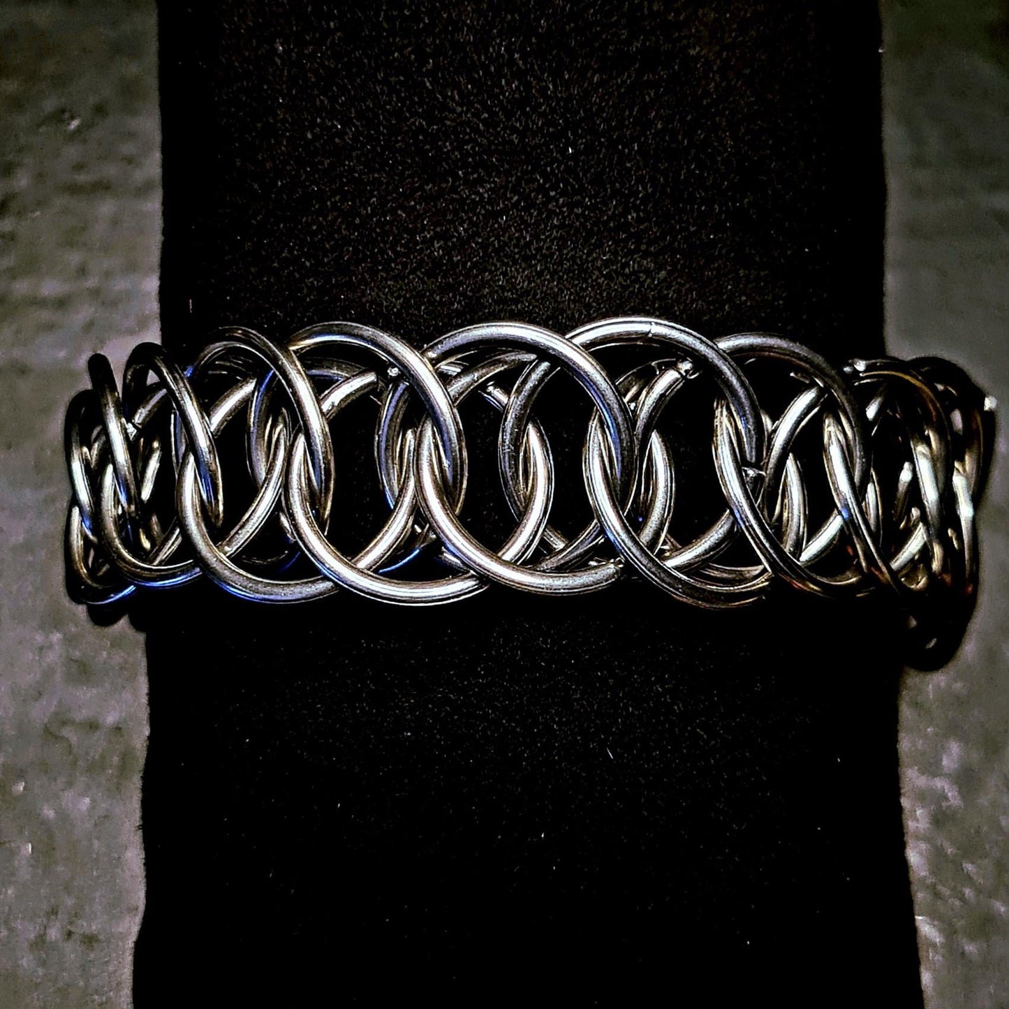 Metallic chainmain punk bracelet on a black background