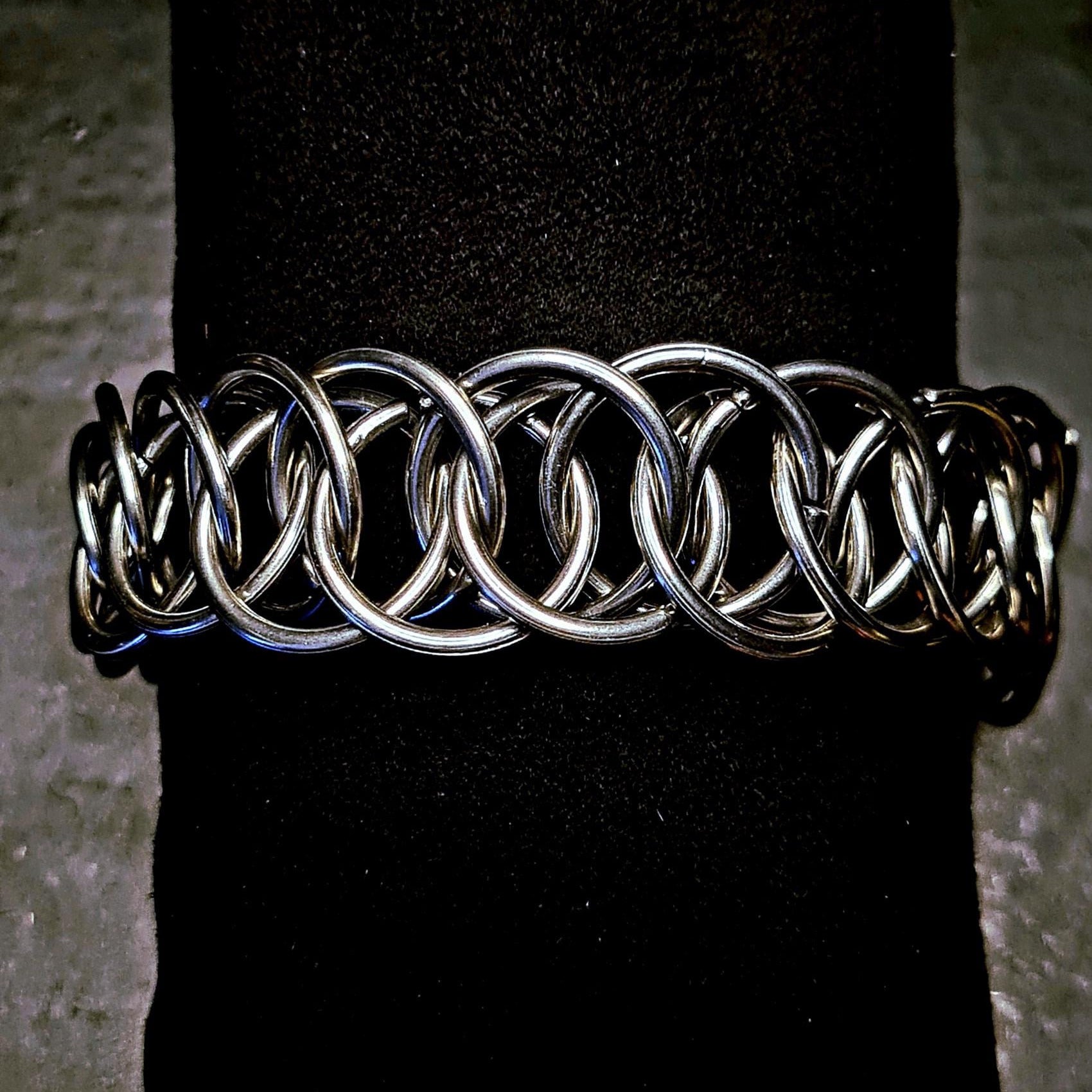 Metallic chainmain punk bracelet on a black background