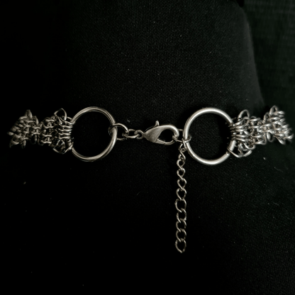 Silver chain necklace on a black background showing lobster clasp