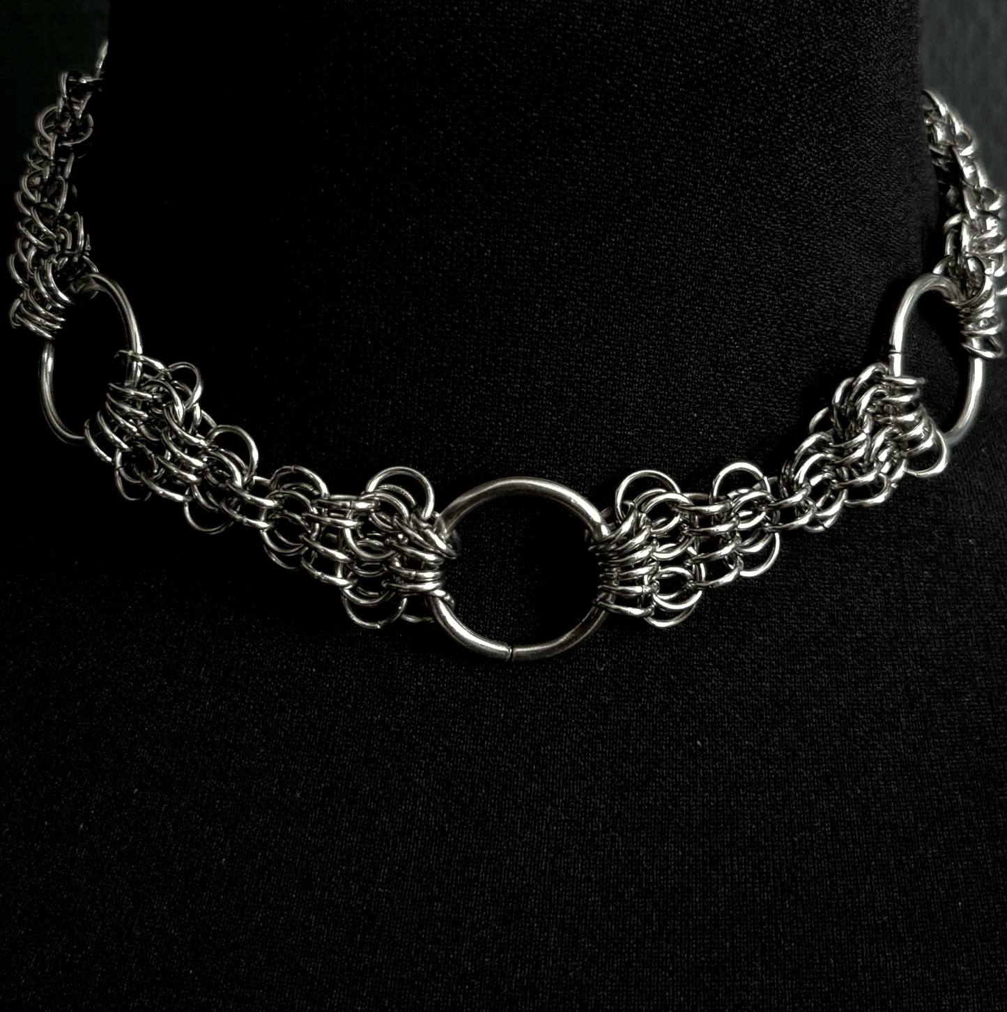 Silver chain necklace on a black background