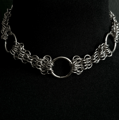 Silver chain necklace on a black background