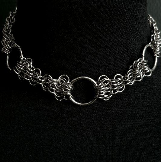 Silver chain necklace on a black background