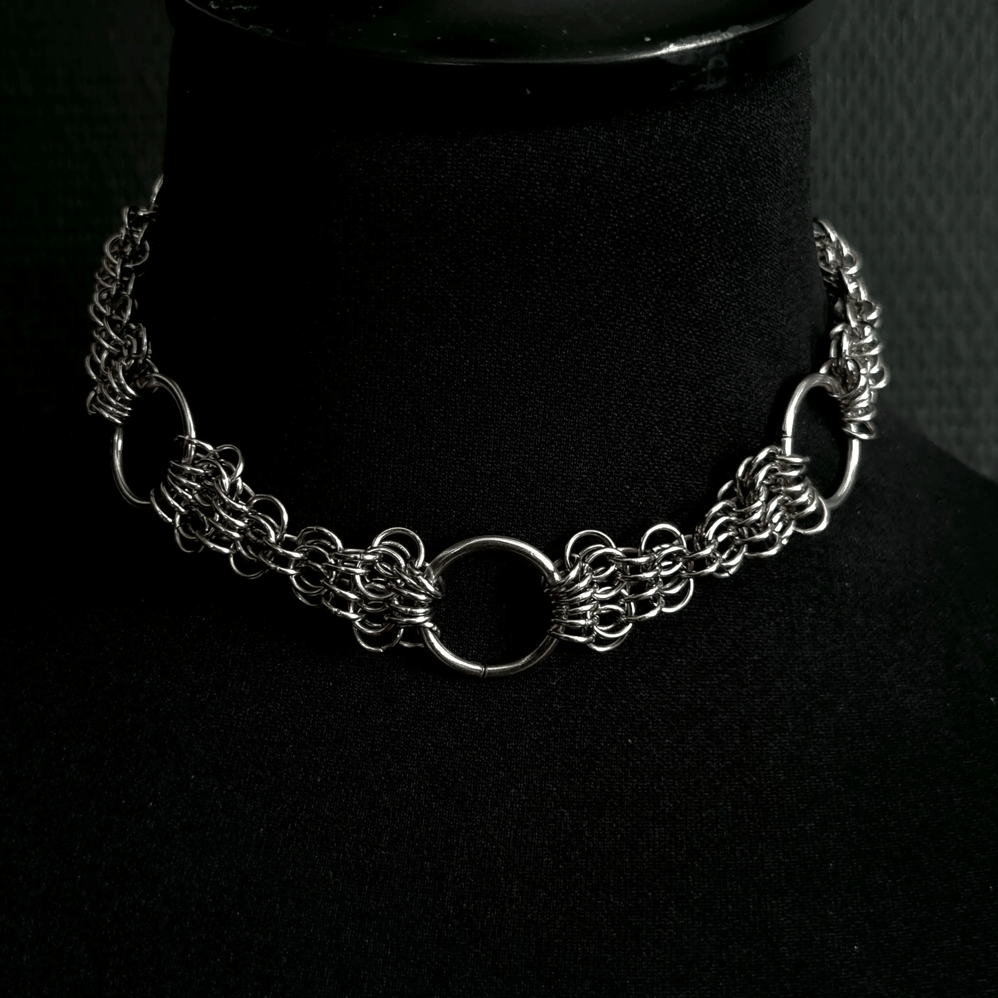 Silver chain necklace on a black mannequin bust