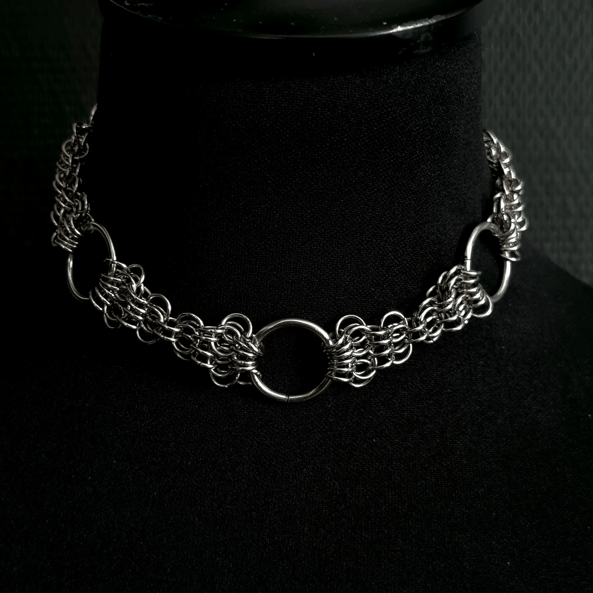 Silver chain necklace on a black mannequin bust