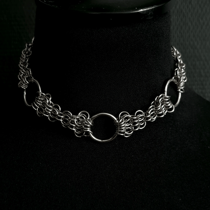 Silver chain necklace on a black mannequin bust