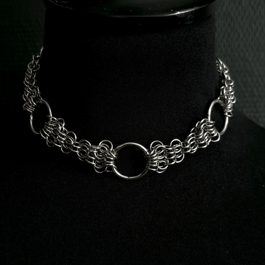 Silver chain necklace on a black mannequin bust